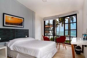 a bedroom with a bed and a view of the ocean at Hotel Volcano in Puerto Villamil