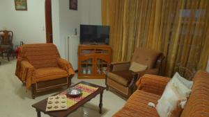 a living room with a couch and a tv at The Village Corner in Politika