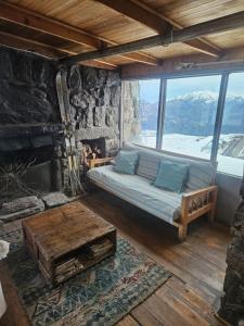 a room with a bed and a fireplace and a table at Cordillera Hostel in Farellones +42 photos