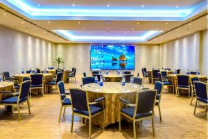 a conference room with tables and chairs and a projection screen at Sheraton Lagos Hotel in Lagos +54 photos