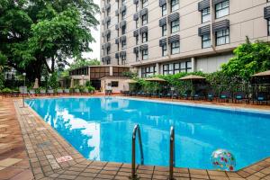 a large blue swimming pool in front of a building at Sheraton Lagos Hotel in Lagos
