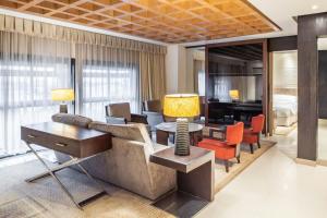 a living room with a couch and a table and chairs at Sheraton Lagos Hotel in Lagos