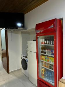 a red refrigerator in a kitchen with drinks at Aldo House in Prekal