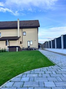 a house with a stone walkway in front of a yard at Casa Bella in Sînpetru +29 photos