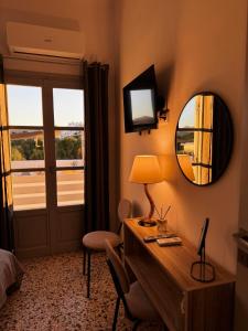 a hotel room with a desk and a mirror at Naousa Nest in Naousa