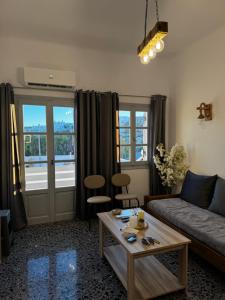 a living room with a couch and a table at Naousa Nest in Naousa
