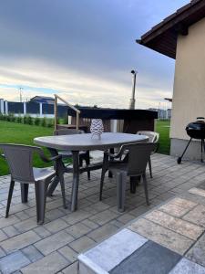 a table and chairs on a patio with a piano at Casa Bella in Sînpetru