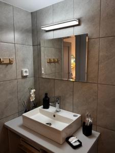 a bathroom with a sink and a mirror at Naousa Nest in Naousa +31 photos
