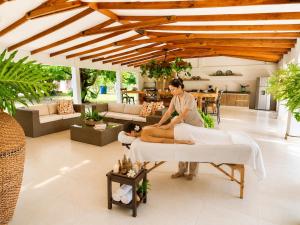 a woman laying on a bed in a room at Villa de lujo a 20 mins Buga con Piscina privada, Jacuzzi y BBQ in Guacarí