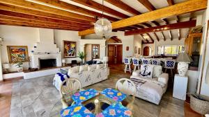 a living room with white furniture and a fireplace at Baja Del Mar 47 in Rosarito Beach
