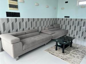 a living room with a couch and a table at Ege Inn in Guraidhoo