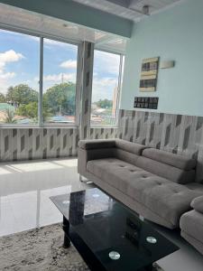 a living room with a couch and a coffee table at Ege Inn in Guraidhoo