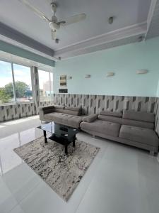 a living room with a couch and a coffee table at Ege Inn in Guraidhoo