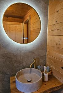 a bathroom with a round sink and a mirror at Chalet Bergliebe Turrach in Turracher Hohe +42 photos