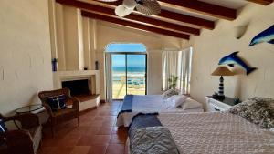 a bedroom with a bed and a view of the ocean at Baja Del Mar 47 in Rosarito Beach