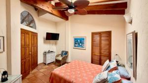a bedroom with a bed and a ceiling fan at Baja Del Mar 47 in Rosarito Beach