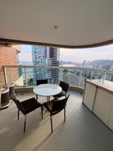 a balcony with a table and chairs on a building at Santos Unique 2701 Jacuzzi & Sea View Duplex in Santos