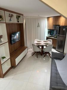 a kitchen and dining room with a table and chairs at Santos Unique 2701 Jacuzzi & Sea View Duplex in Santos