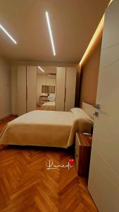 a bedroom with a large bed and a wooden floor at La casa del sole in Trofarello