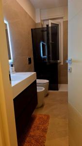 a bathroom with a sink and a toilet at La casa del sole in Trofarello +7 photos