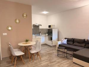 a living room with a couch and a table and chairs at Lalya App in Vodnjan