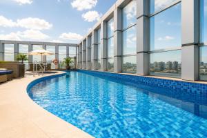 a swimming pool on the roof of a building at Alugueasy - Hotel Vision in Brasília