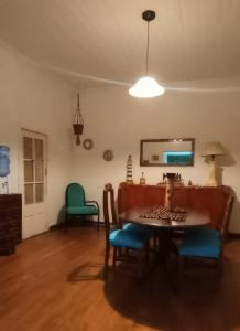 a dining room with a table and a chair at Wind & Way Hostel in Valparaíso +9 photos