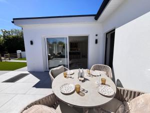 a table and chairs sitting on a patio at Luxury sea view villa in Ballycastle