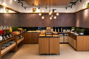 a large kitchen with a bunch of food on counters at Alugueasy - Hotel Vision in Brasília