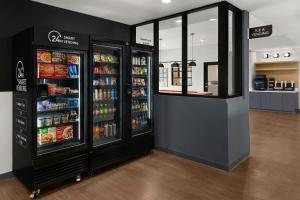 a store with two large refrigerators in a grocery store at StudioRes by Marriott Leland in Leland