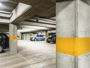 a parking garage with cars parked in it at ibis Gent Centrum Opera in Ghent