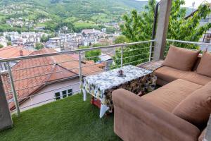 a balcony with a table and chairs and a view at Guest House Lejla in Travnik