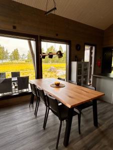 a wooden table and chairs in a room with a kitchen at Sea Haven Villa in Trutberget +28 photos