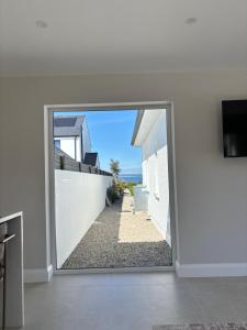 a view of a hallway through a sliding glass door at Luxury sea view villa in Ballycastle