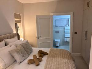 two teddy bears sitting on a bed in a bedroom at Luxury sea view villa in Ballycastle