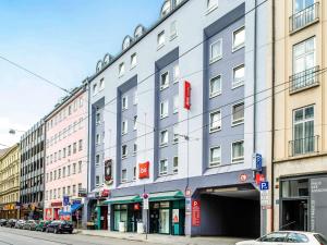 a large building on a city street with buildings at ibis Hotel München City in Munich