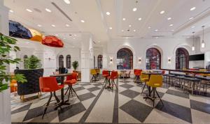 a lobby with colorful chairs and tables in a building at Warwick Allerton Chicago in Chicago