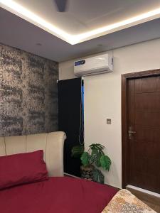 a bedroom with a bed and a air conditioner at The crimson round bed luxe suite in Rawalpindi