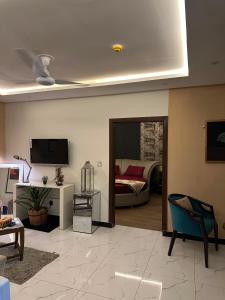 a living room with a bed and a tv at The crimson round bed luxe suite in Rawalpindi