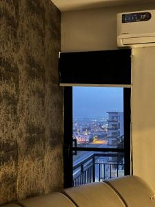 a window in a room with a view of a city at The crimson round bed luxe suite in Rawalpindi