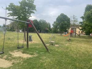 an empty playground with swings and a slide at Giulieda in SUNSHINE giardino privato in Sanfatucchio