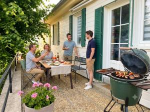 a group of people on a patio with a grill at Caporizon-La Marote-Gite calme tout neuf in Lanobre