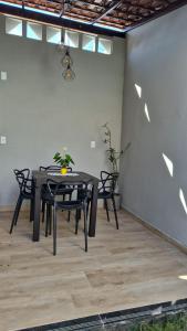 a black table and chairs on a patio at Casa Real in Guarapari +16 photos