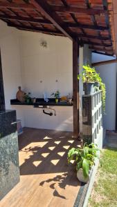 a kitchen with a counter and some potted plants at Casa Real in Guarapari