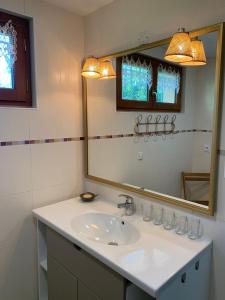 a bathroom with a sink and a mirror at La Maison d'Ecluse No17 - Chambres d'hôtes in Castelsarrasin