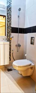 a bathroom with a toilet and a sink at White Bloom - Kfardebian 6836 in Kfardebian +12 photos