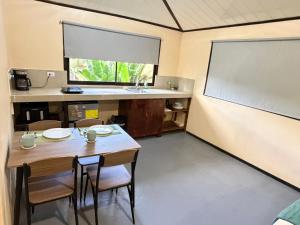 a classroom with a table and chairs and a chalkboard at Estudio Jaguar in Tortuguero +11 photos