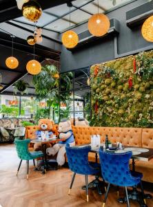 a restaurant with teddy bears sitting on a bench at Hotel Suites Feria de Madrid in Madrid +49 photos