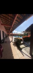 a building with a patio with a view of the water at Pousada Caranã in Salinópolis