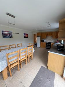 a kitchen and living room with a table and chairs at Kilmurry heights in Kenmare +4 photos